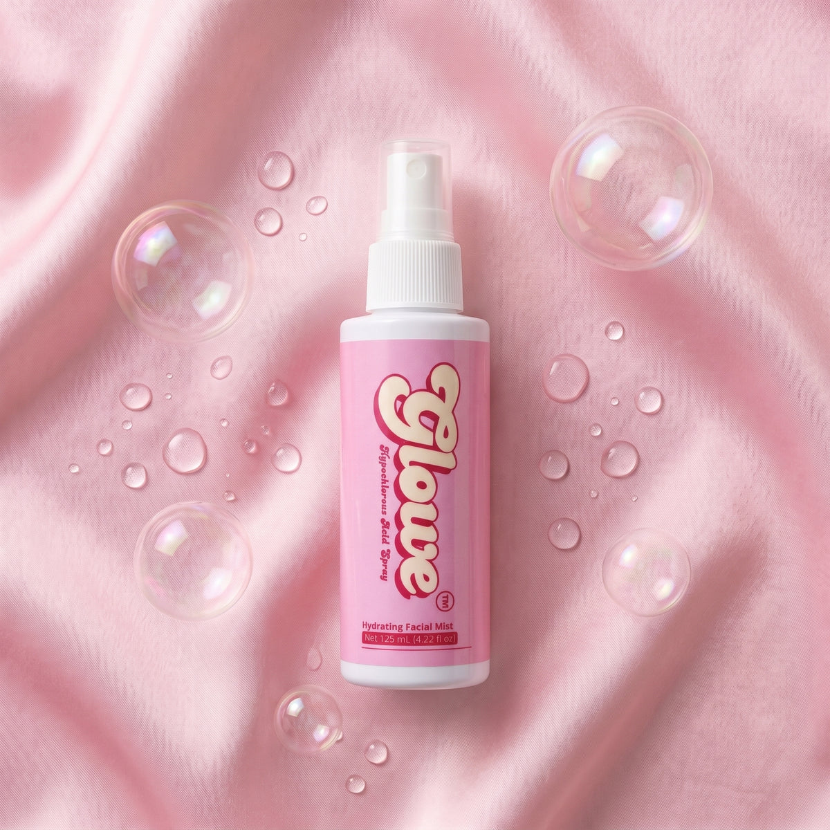 Glowe Hypochlorous Acid Spray 125 mL bottle flatlay on pink satin with bubbles