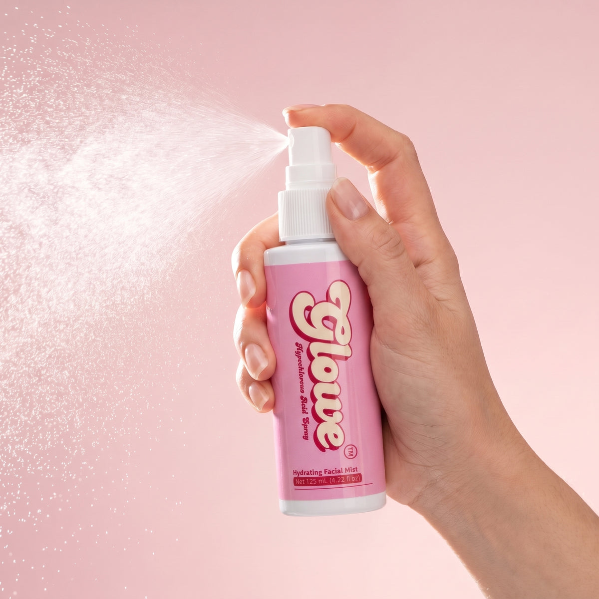 Hand spraying Glowe Hypochlorous Acid facial mist from 125 mL bottle
